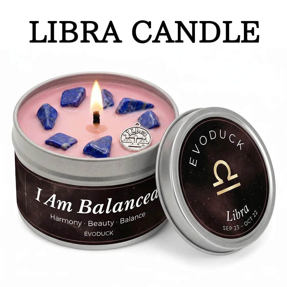 Libra zodiac candle in a metal tin with pink wax, blue crystals, and a silver Libra charm, lit with a single wick.