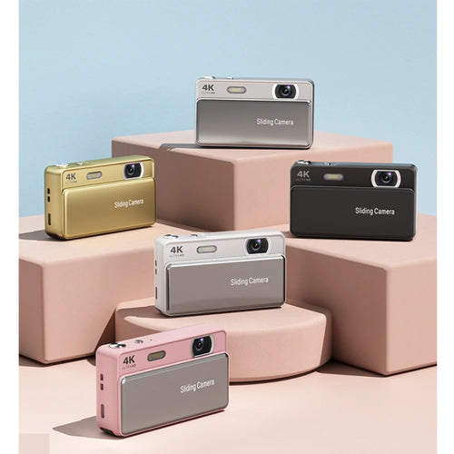 Five compact 4K digital cameras with sliding lens covers in gold, silver, black, white, and pink metallic finishes.