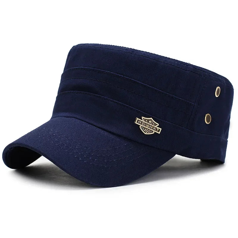 Navy blue flat-top military-style cotton cap with a metal emblem and side eyelet details.