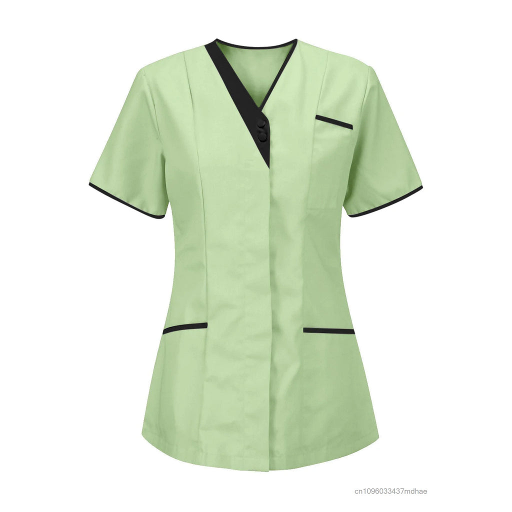 Mint green short-sleeved salon tunic with a V-neck, black trim detail, and two front pockets.