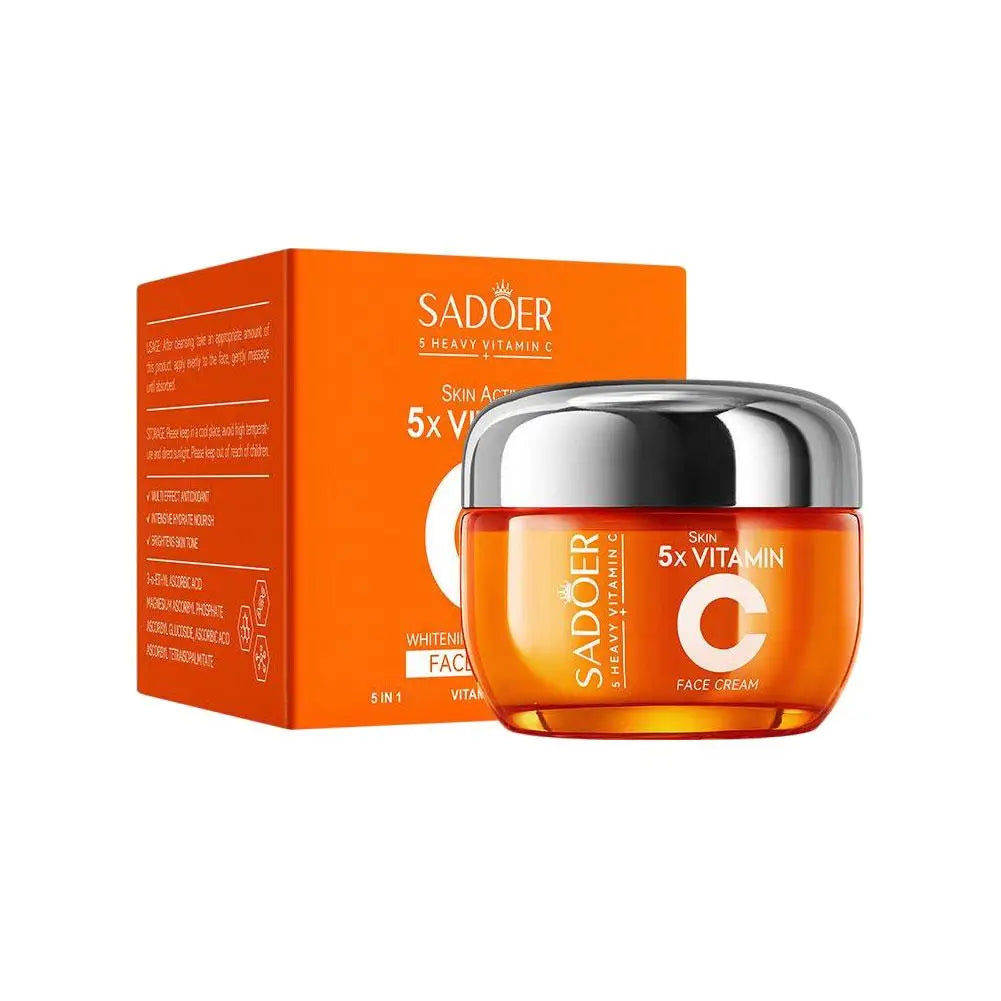 Orange jar of 5x Vitamin C face cream with a silver lid, displayed in front of its matching orange product box.