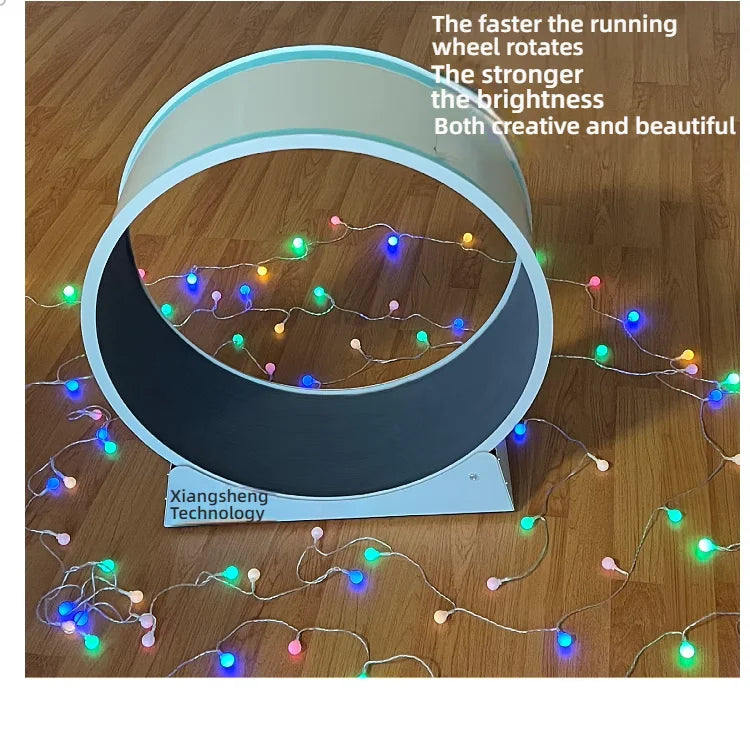 White interactive pet exercise wheel on a wooden floor, surrounded by colourful LED fairy lights.