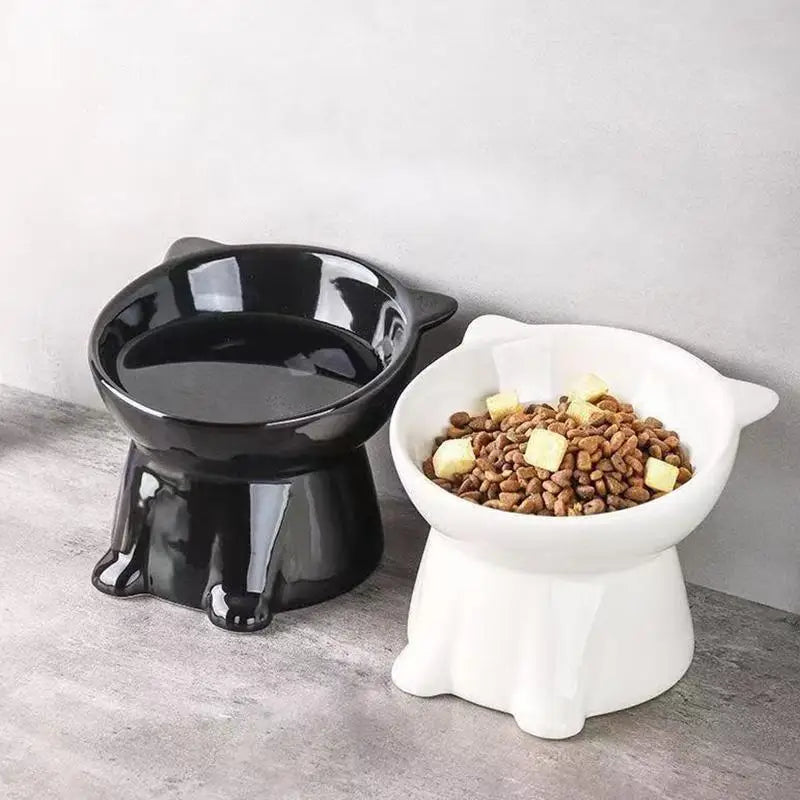 Two black and white cat-eared, elevated pet bowls with a 15-degree tilt for comfortable feeding.