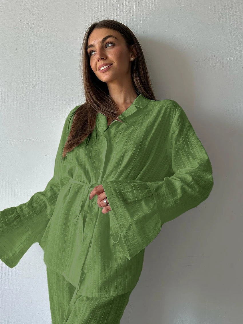 Sage green button-up shirt with a collar, tie waist, and long flared sleeves in a textured, lightweight fabric.