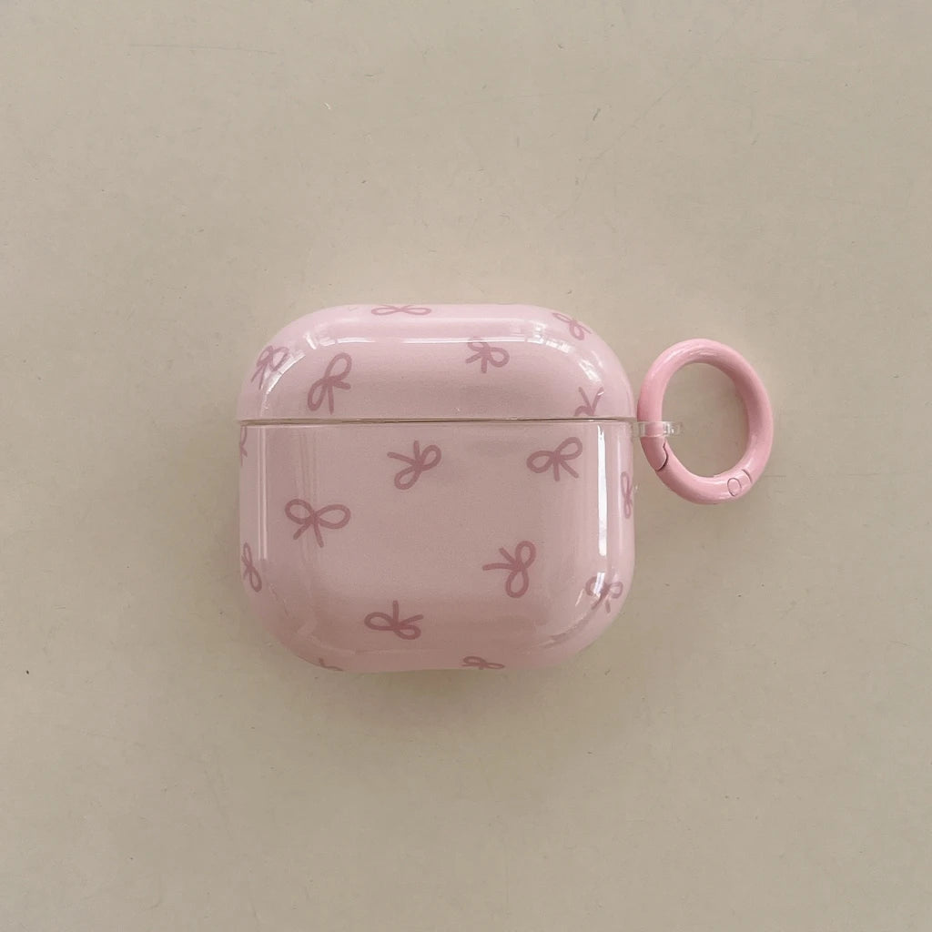 Glossy pink AirPods case with a cute bow print and matching carabiner ring. Compatible with AirPods 3.