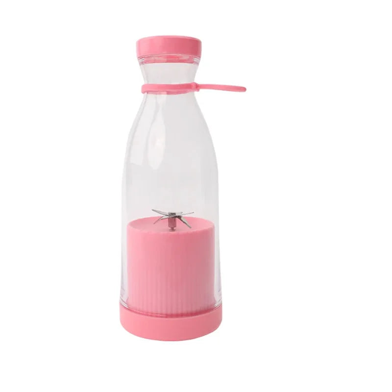 Portable personal blender with a clear bottle, pink base, lid, and internal metal blades.