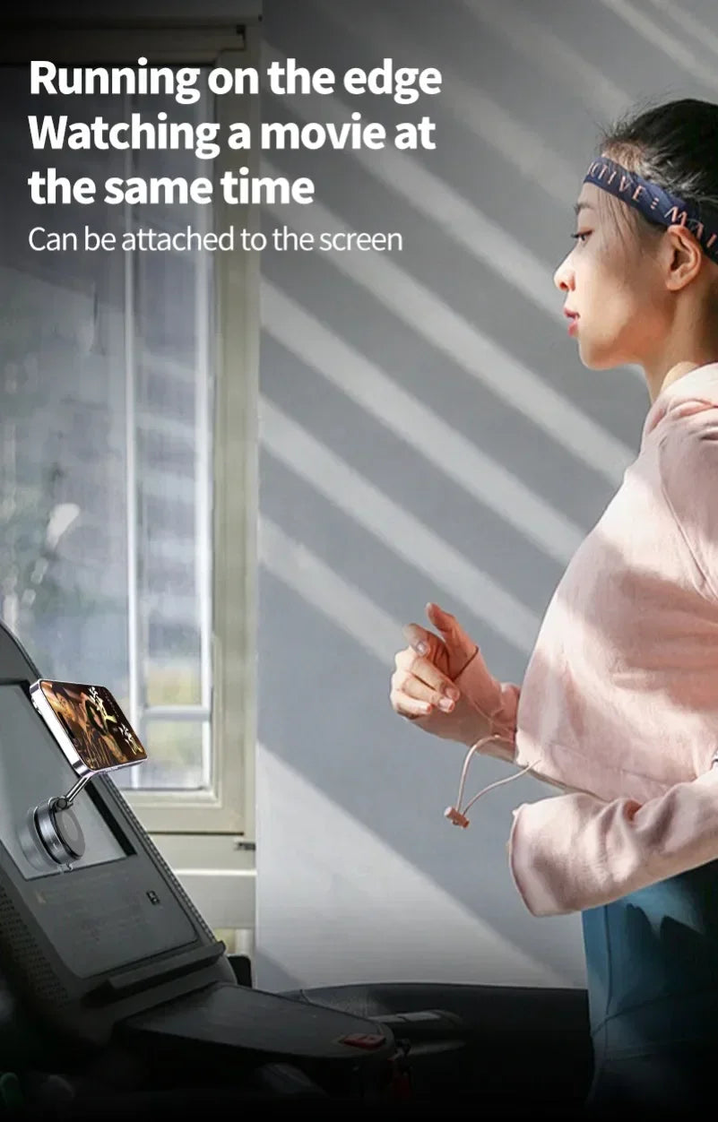 A silver, magnetic smartphone mount attached to a treadmill console, holding a phone for viewing while running.