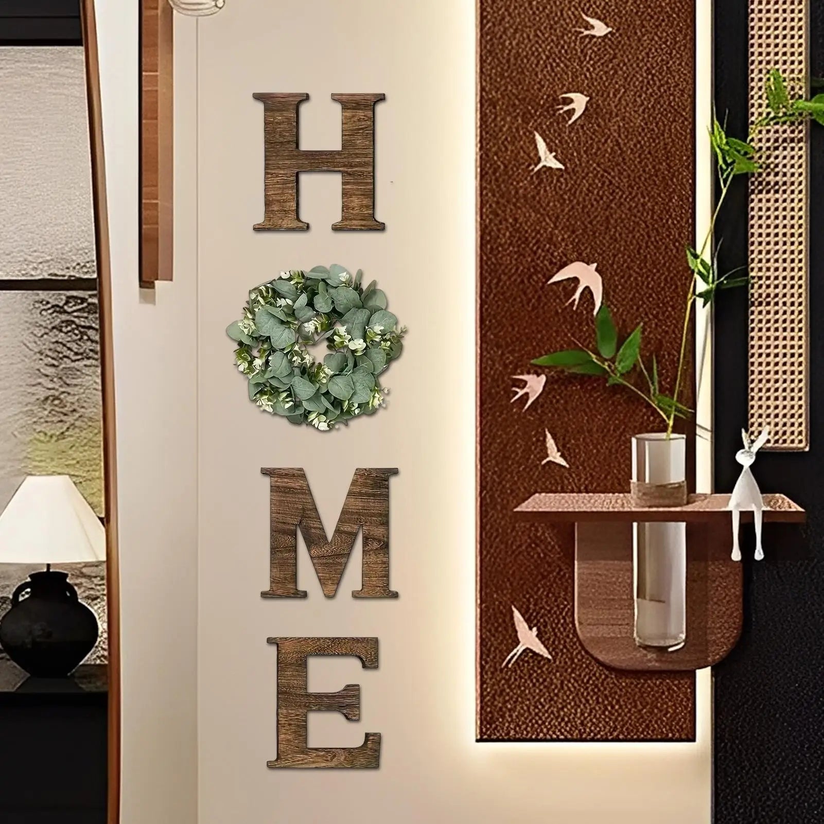 Rustic wooden ‘HOME’ wall letters with a decorative artificial eucalyptus wreath replacing the letter ‘O’.