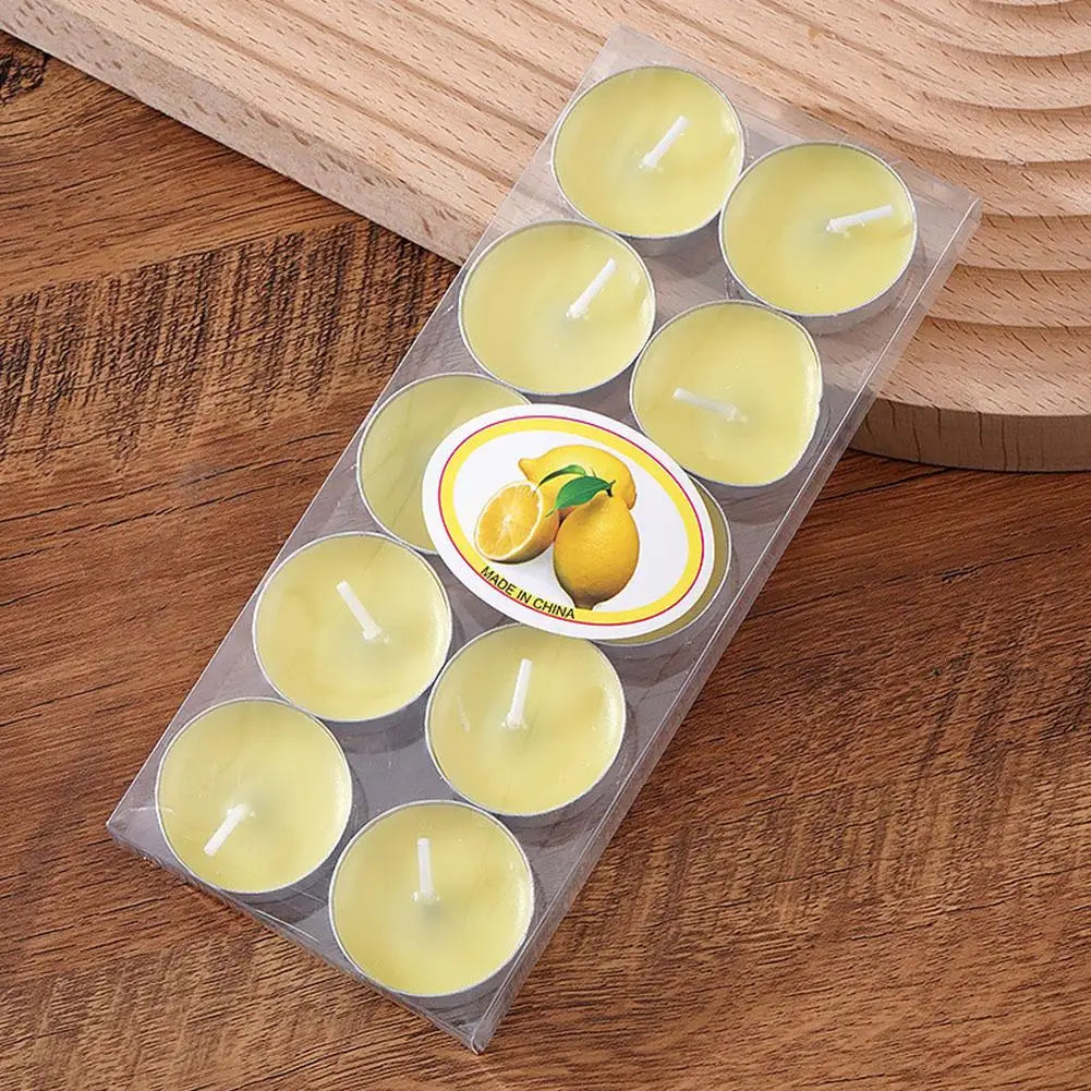 Pack of yellow lemon-scented tea light candles in a clear plastic tray on a wooden surface.