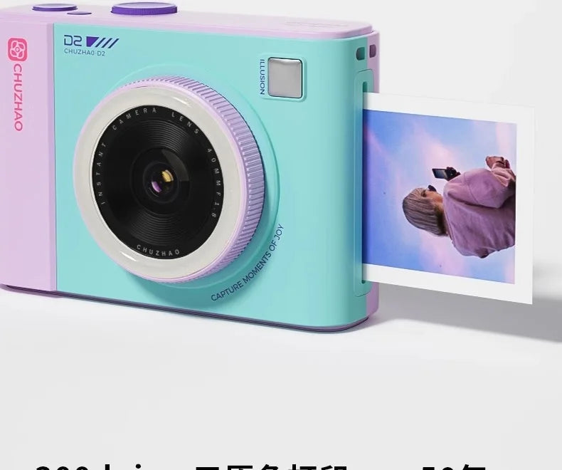 Turquoise and purple plastic instant film camera with a black lens, ejecting a printed square photo.
