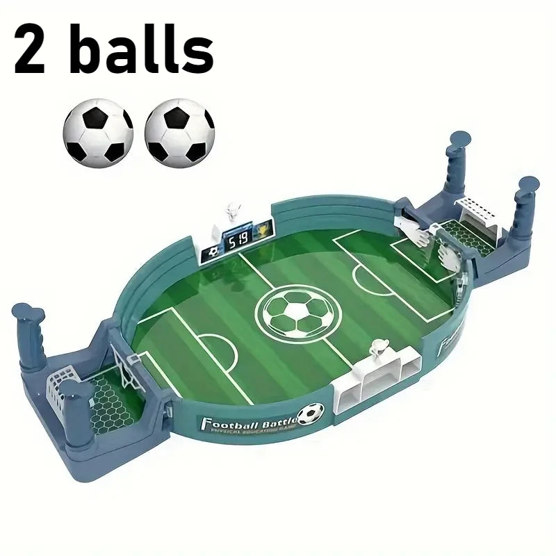 Tabletop football battle game with a green pitch, goal nets, manual scorekeepers, and two mini footballs.