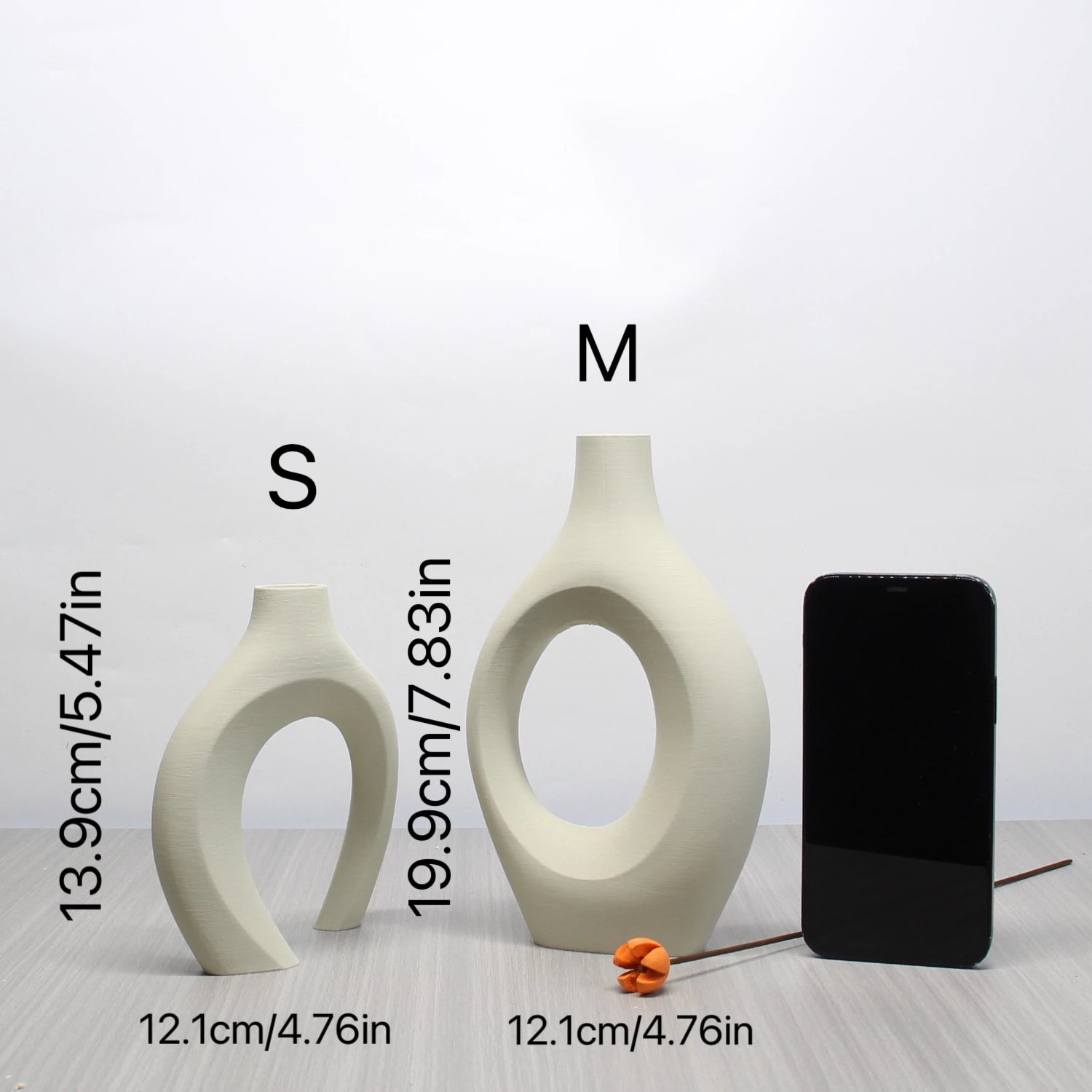 Two cream-coloured, abstract Bohemian-style vases with cut-out centres, shown in small and medium sizes.