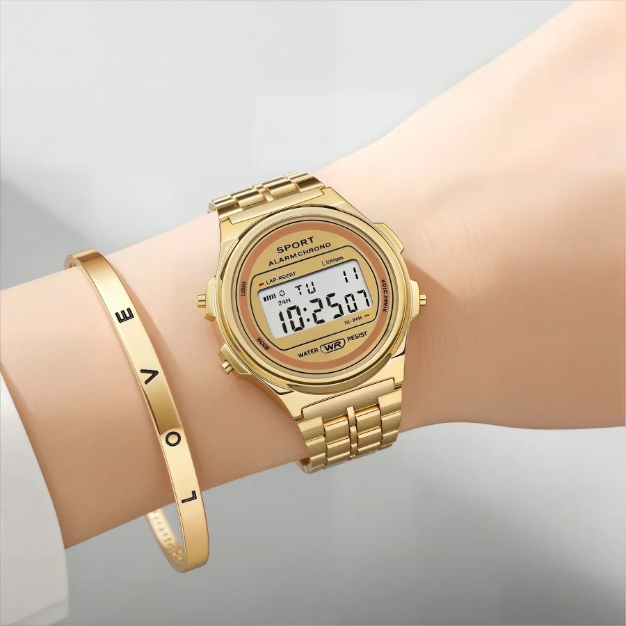 A gold-tone retro digital watch with a metal link strap, worn with a matching 'LOVE' inscribed bangle bracelet.