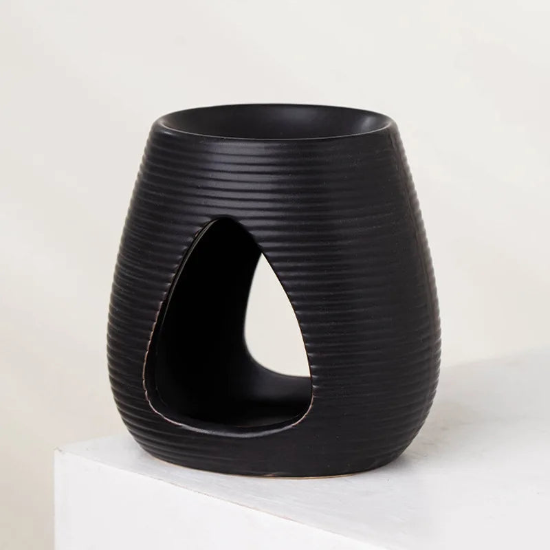 Matte black ribbed ceramic wax melt or oil burner with a wide open front for a tealight candle.