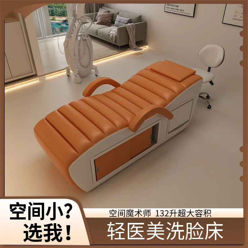 Orange and white professional massage bed featuring a sleek, modern design with built-in hidden storage compartments.