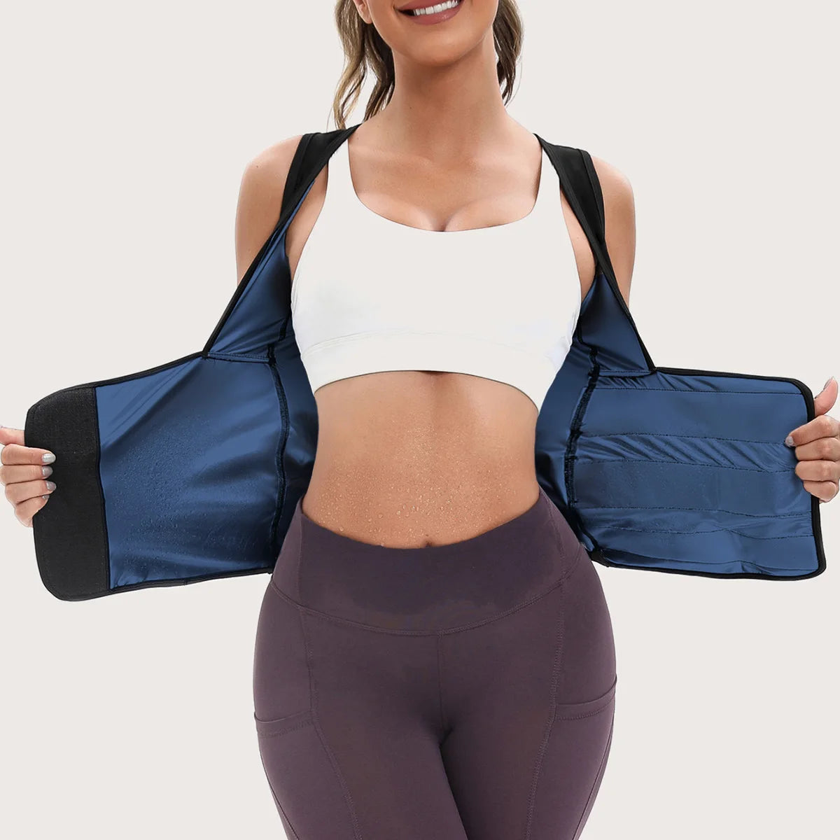 A woman wearing a black and blue sweat-enhancing neoprene waist trainer vest with a supportive zip-up front.