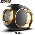 Compact, egg-shaped portable black and gold Bluetooth speaker with a metallic speaker grille and bass radiator.