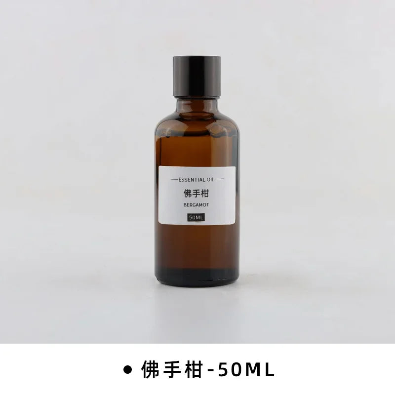 50ml amber glass essential oil bottle with a black screw cap and a minimalist label reading Bergamot.