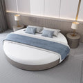 Modern minimalist circular bed frame in grey, styled with white bedding, blue cushions, and a matching grey bed runner.