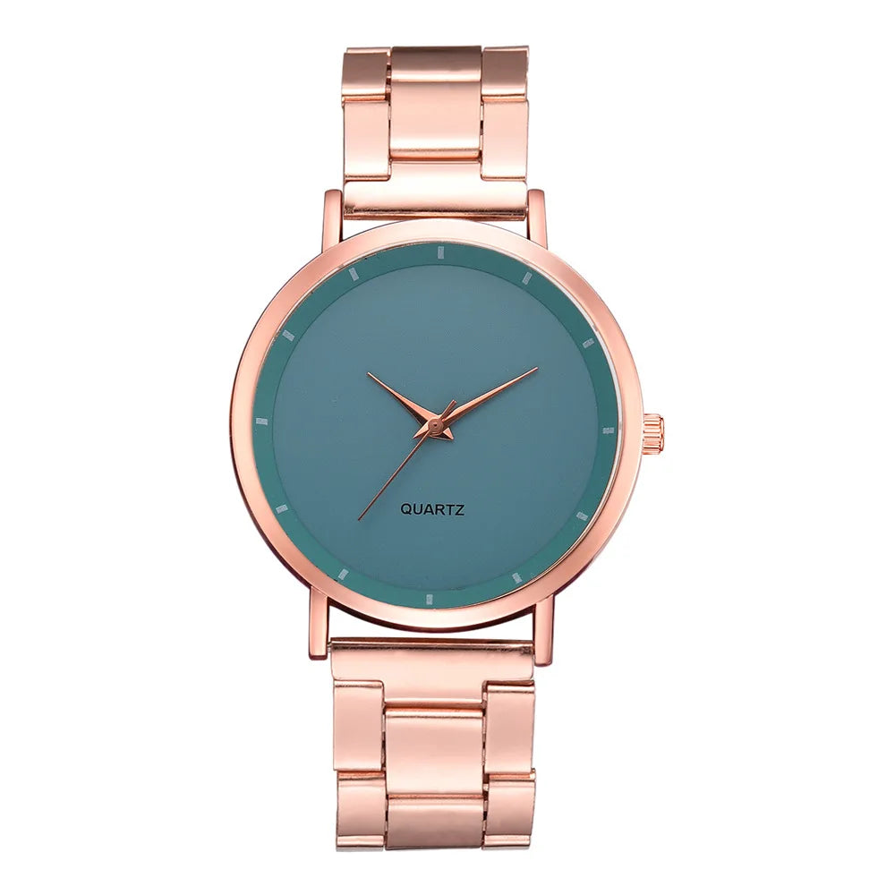 Ladies’ watch with a rose gold stainless steel link strap, round case, and a minimalist teal-blue dial.