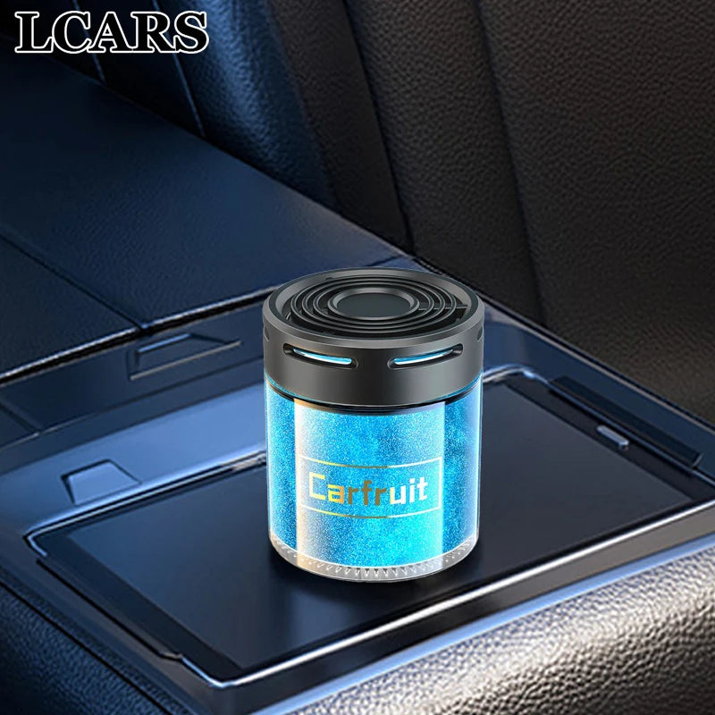 Compact blue car air freshener with a sleek black top, placed on a vehicle centre console.