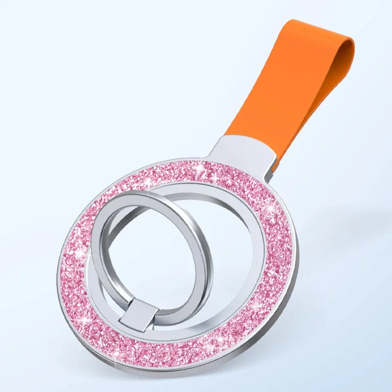 Round phone ring holder with a sparkly pink glitter border and an attached orange strap.