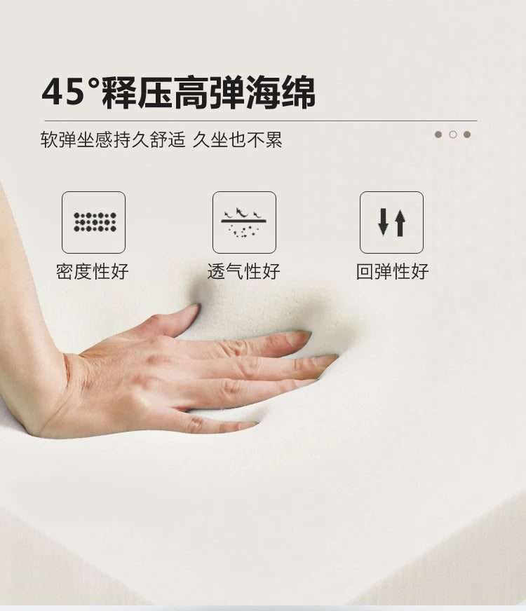 A hand pressing into high-density, breathable cream-coloured foam, highlighting its soft and supportive texture.