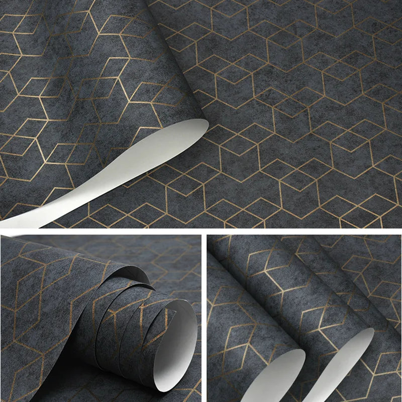 Modern geometric wallpaper roll featuring a dark grey textured background with a metallic gold cube pattern.