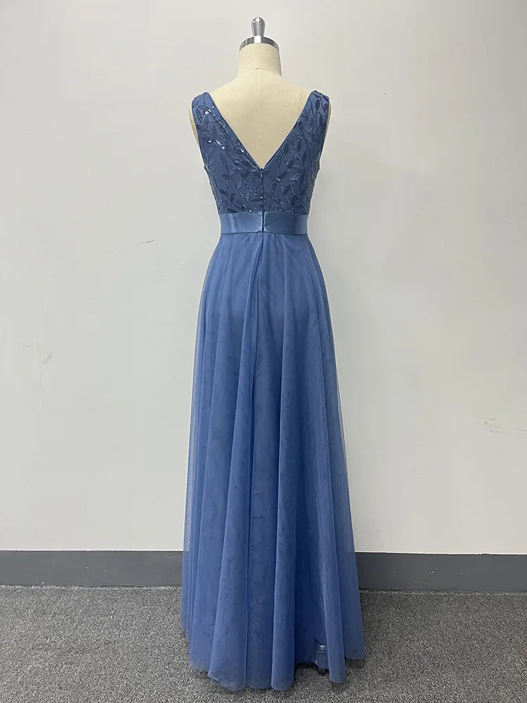 Back view of a dusty blue maxi dress on a mannequin, featuring a V-back, sequined bodice, and mesh skirt.