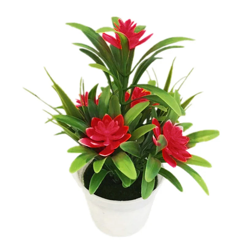 Artificial potted plant with vibrant red flowers and green pointed leaves in a small, simple white pot.