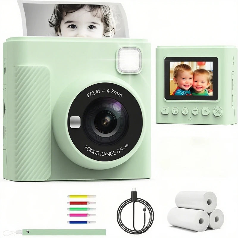 Light green plastic instant print camera with LCD screen, lens, charging cable, marker pens, and thermal paper rolls.