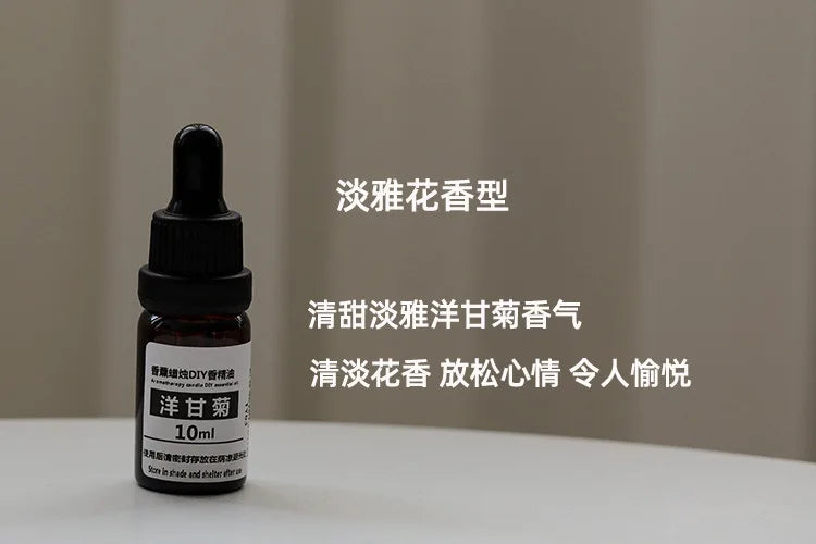 Small 10ml amber glass bottle of chamomile essential oil with a black dropper cap, standing on a white surface.