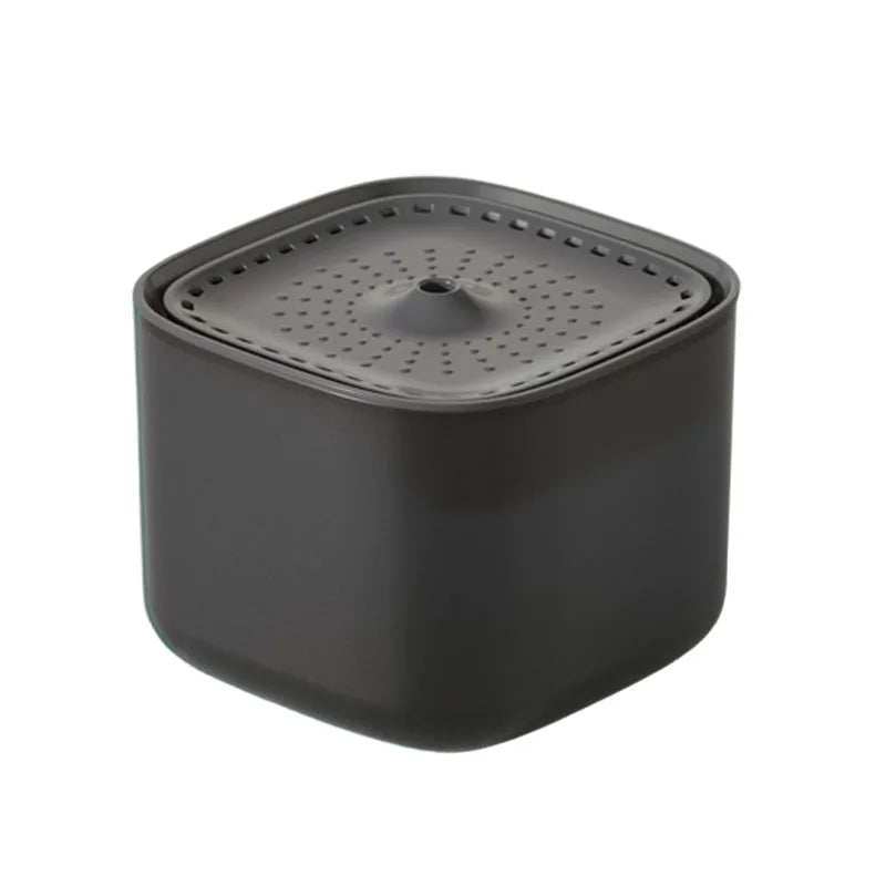 A square, charcoal-grey pet water fountain with a perforated top surface and a central spout for water flow.