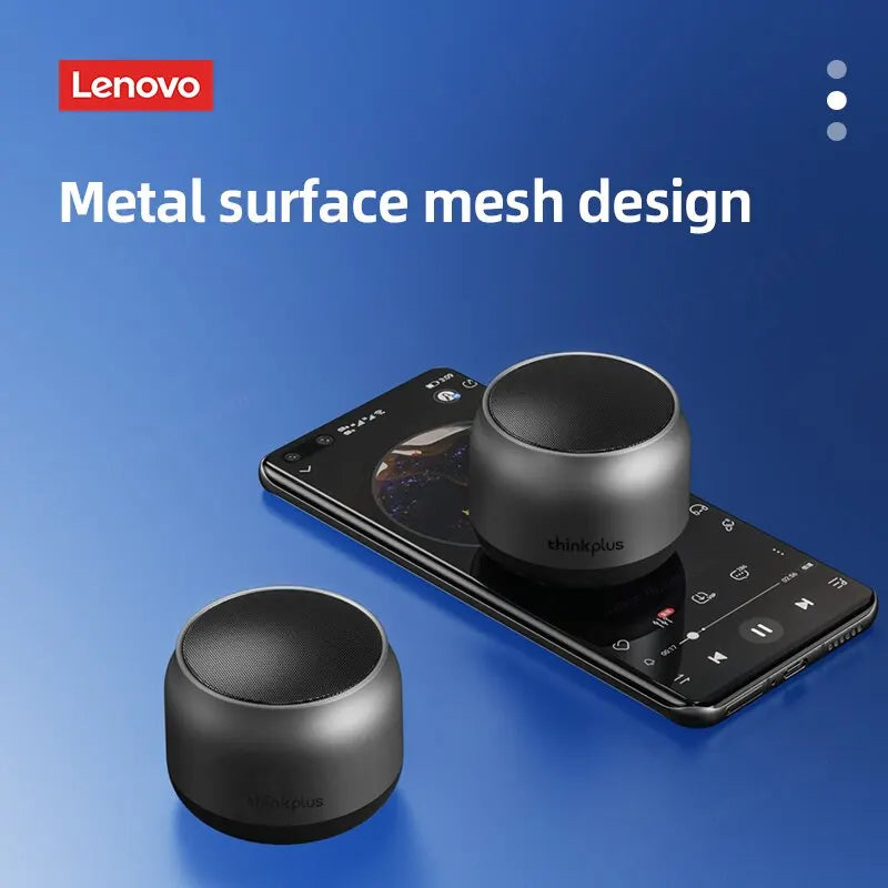 Two compact, grey metallic portable Bluetooth speakers with a mesh top design, one placed on a smartphone screen.