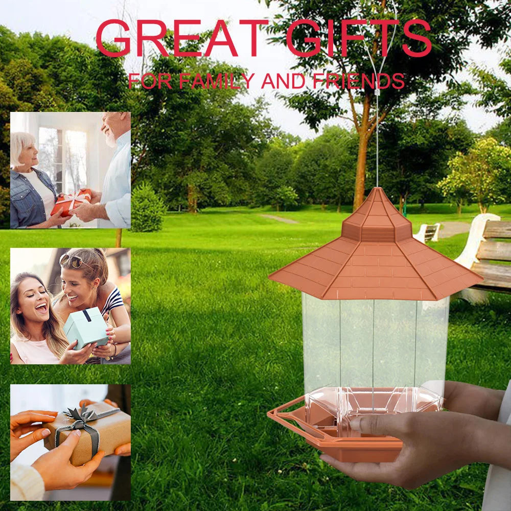 Hanging gazebo-style bird feeder with a brown plastic roof and clear seed container held in hands.