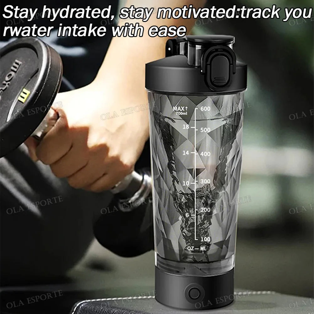 Black, faceted-design plastic protein shaker bottle with volume markings, shown held near a dumbbell.