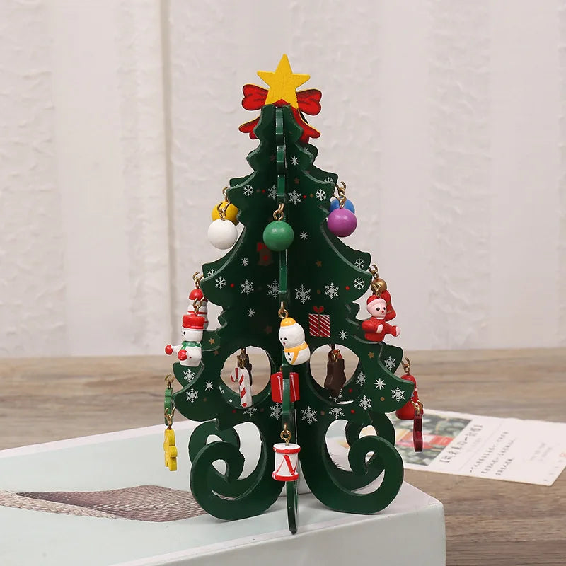 A dark green wooden Christmas tree ornament decorated with hanging colourful baubles and festive figures, topped with a star.