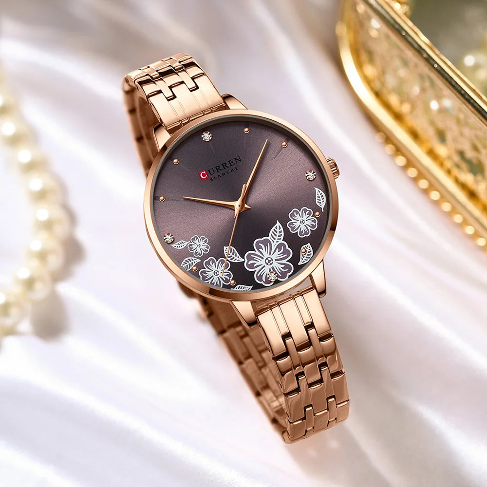 Rose gold Curren women's watch with round purple floral dial and link bracelet.