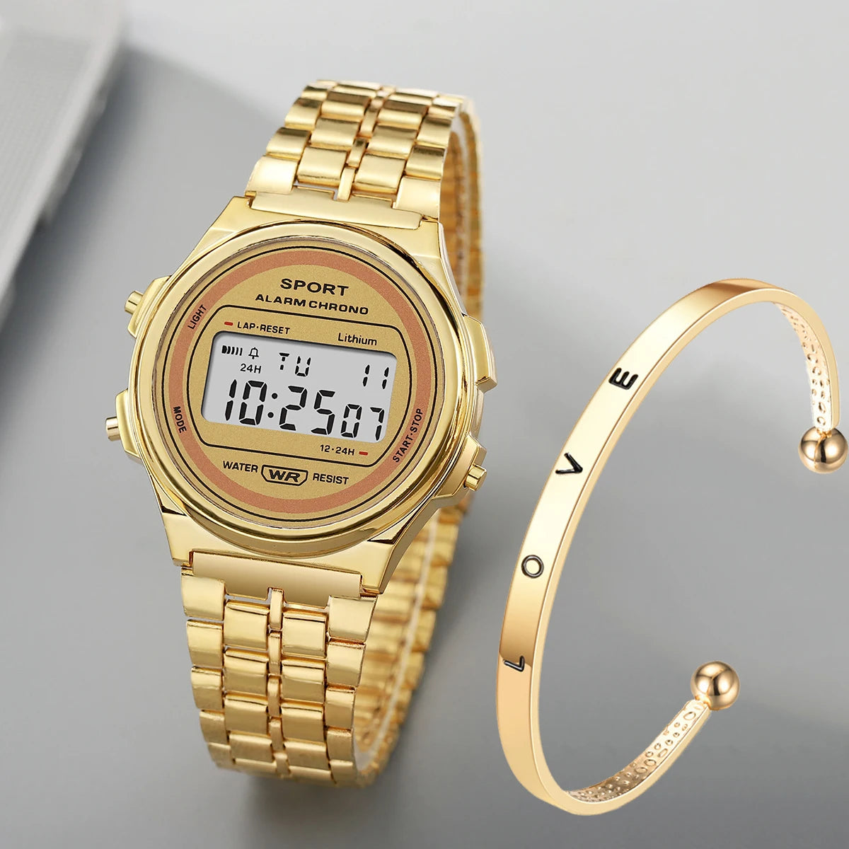 Gold-tone retro digital watch with a matching cuff bracelet inscribed with the word 'LOVE'.
