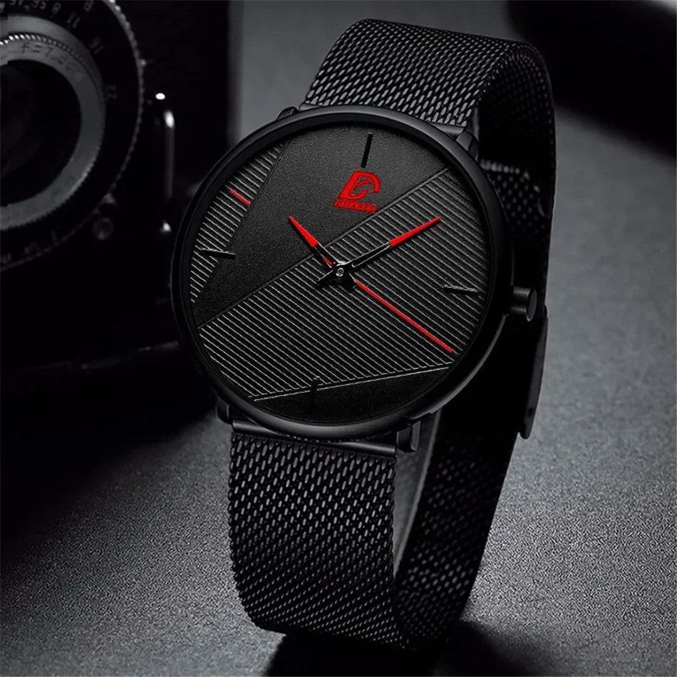 Minimalist men's ultra-thin quartz watch with a black mesh strap and textured black dial with vibrant red hands.