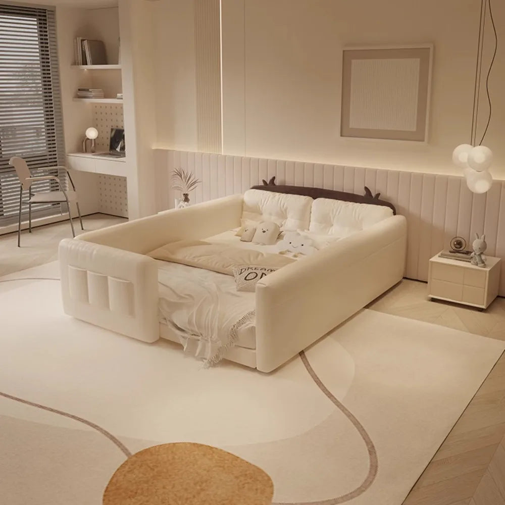 Cream-coloured parent-child bed with protective guardrails, integrated storage pockets, and cute cow-ear headboard detail.