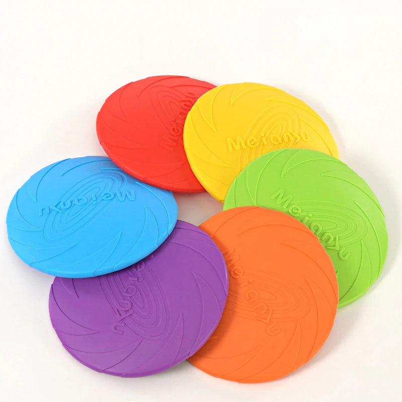 A set of six colourful silicone flying disc dog toys in red, yellow, green, orange, purple and blue.