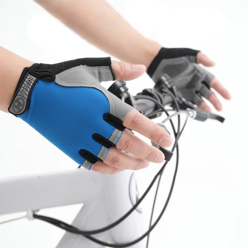 Blue and grey fingerless cycling gloves with a Velcro wrist strap, being worn while gripping bicycle handlebars.