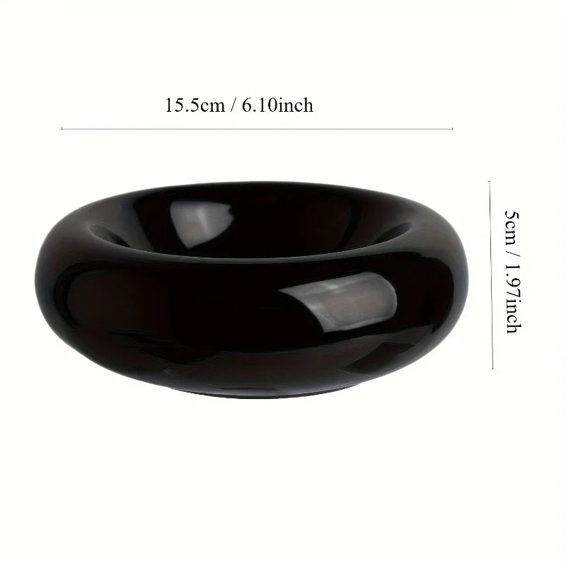 Glossy black ceramic cat feeding bowl with a rounded, low-profile design. Measures 15.5cm wide by 5cm high.