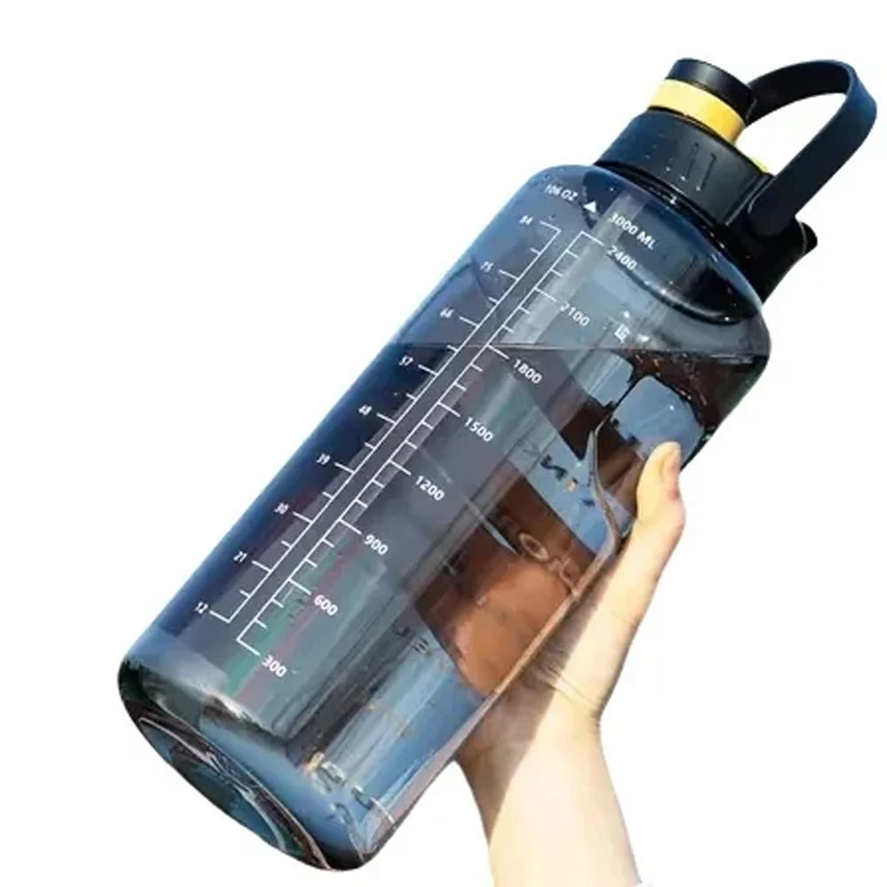 Large, translucent grey 3-litre water bottle with capacity markings, black lid, and carry handle held by a hand.