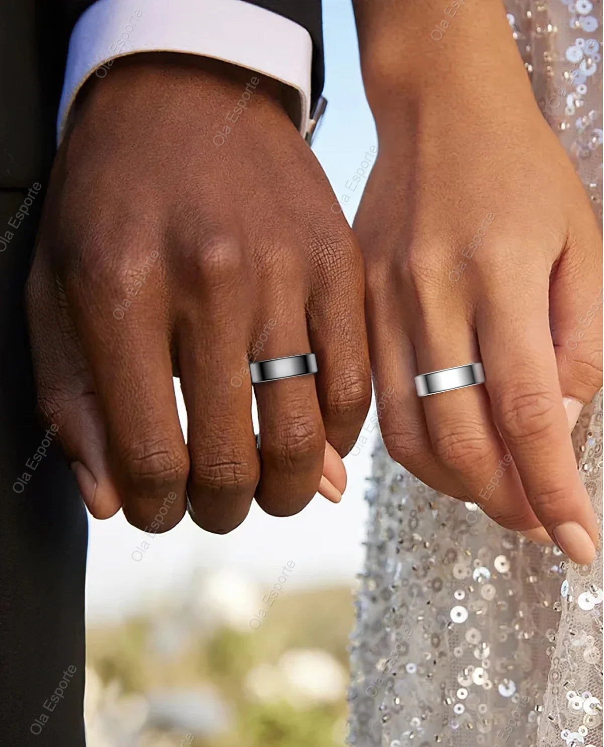 A couple wearing sleek, silver smart health rings on their wedding fingers, blending fitness tracking with modern style.