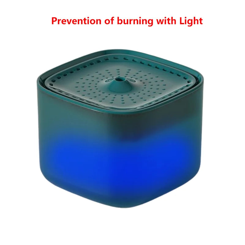 Square, teal pet water fountain with a perforated top and blue internal LED light on a white background.