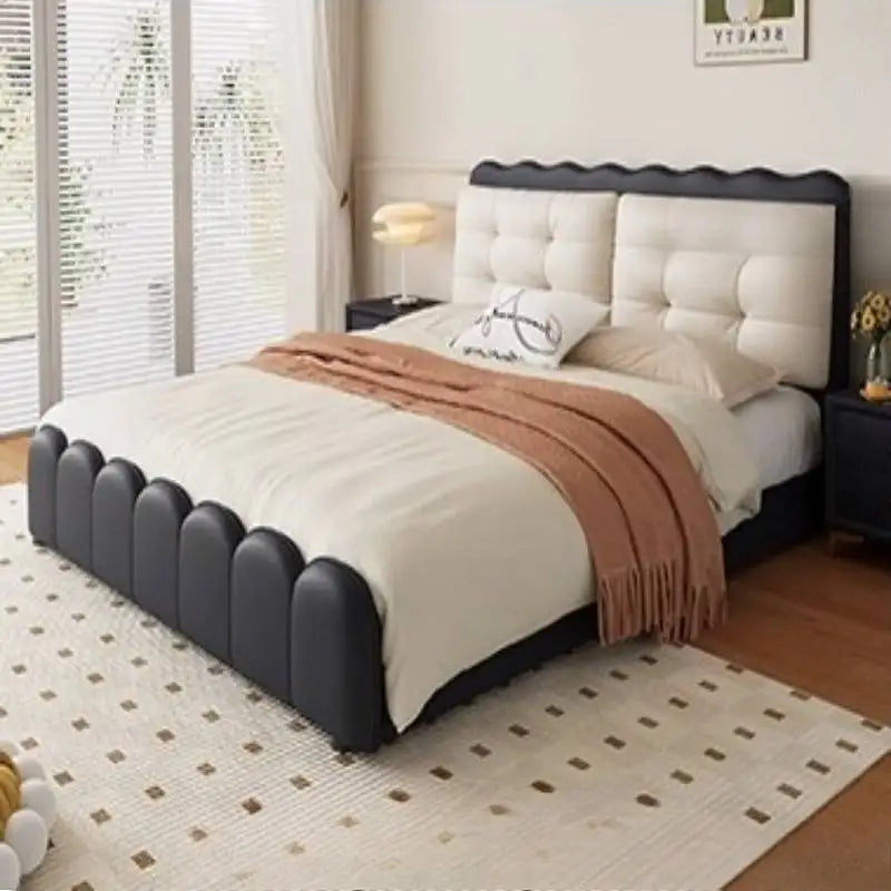 Modern black and white platform bed with a scalloped frame, button-tufted headboard, and integrated storage base.