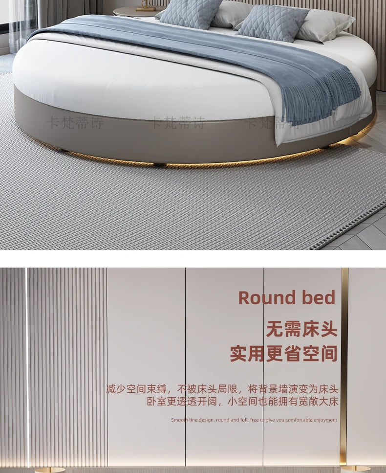 Modern minimalist round bed frame in taupe faux leather with integrated base lighting, dressed with blue textiles.
