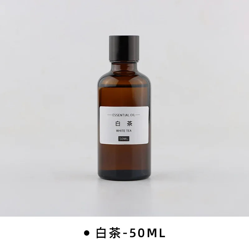 50ml amber glass bottle of White Tea essential oil with a minimalist black cap and white label.